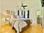 King Bed in Guest Room  with ceiling fan and tv